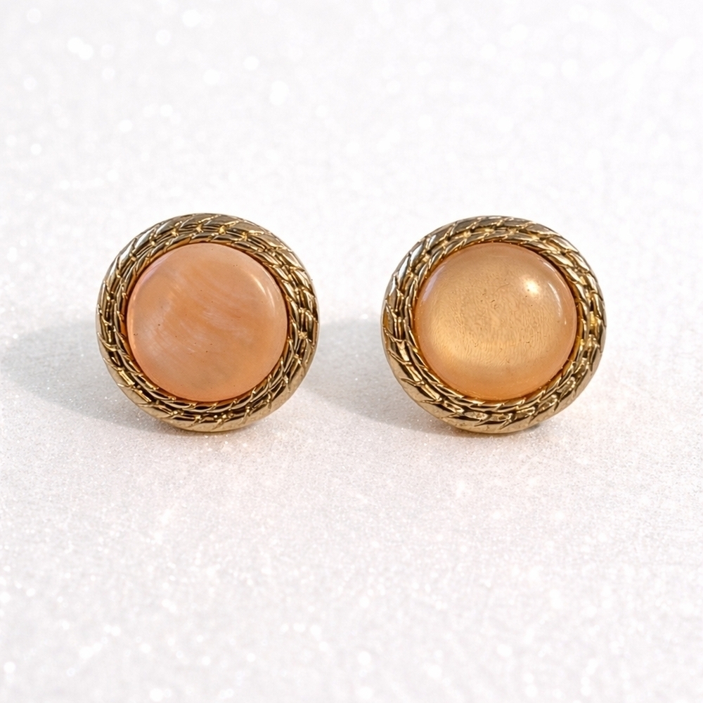 Vintage gold-tone clip-on earrings with pink moonglow cabochons.